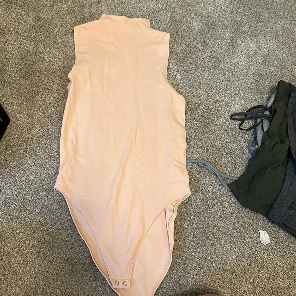 Brand new cream colored body suit from Just Fab. Never been worn